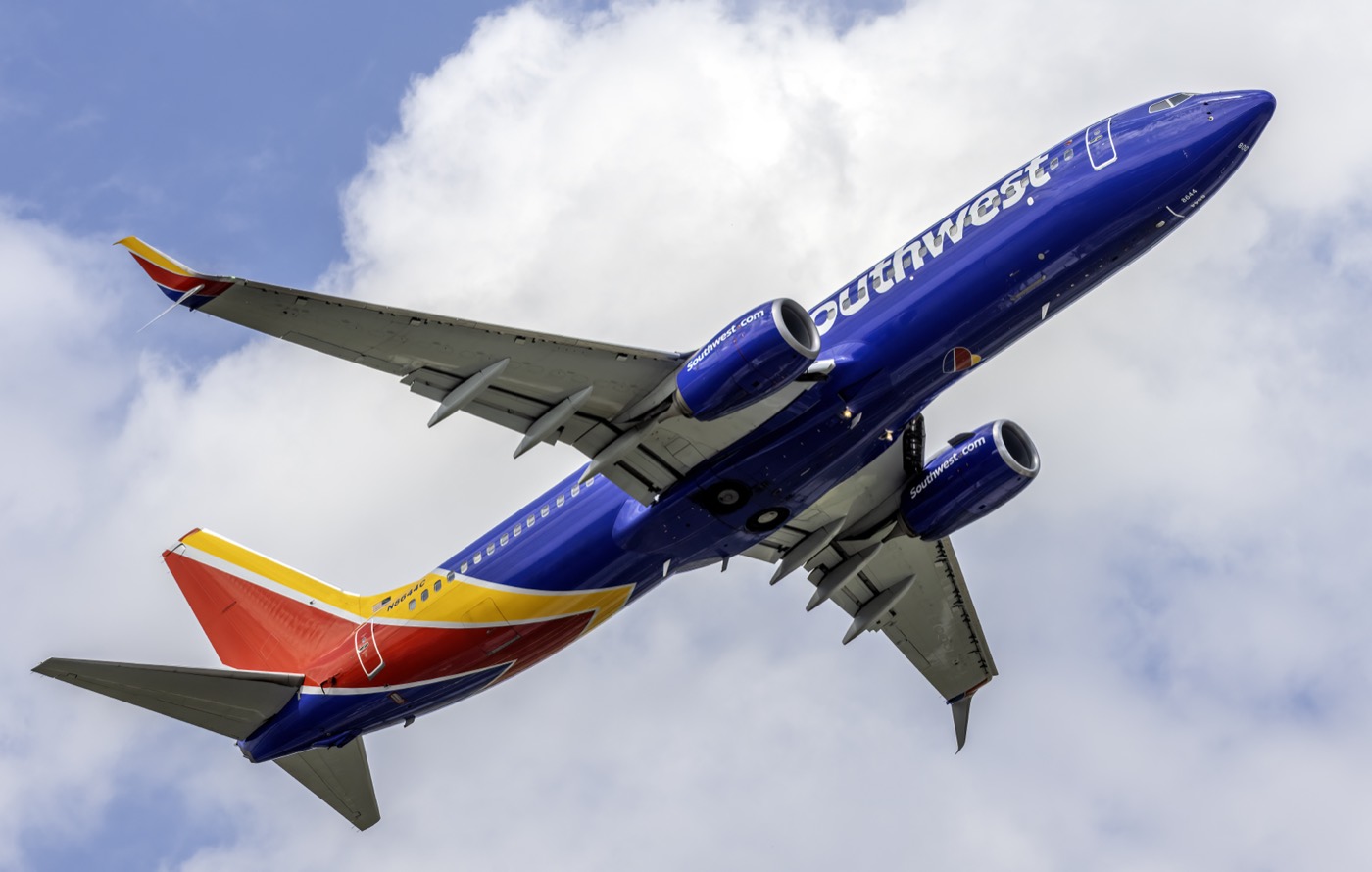 A Southwest Airlines Boeing 737 climbing after takeoff against a cloudy sky
