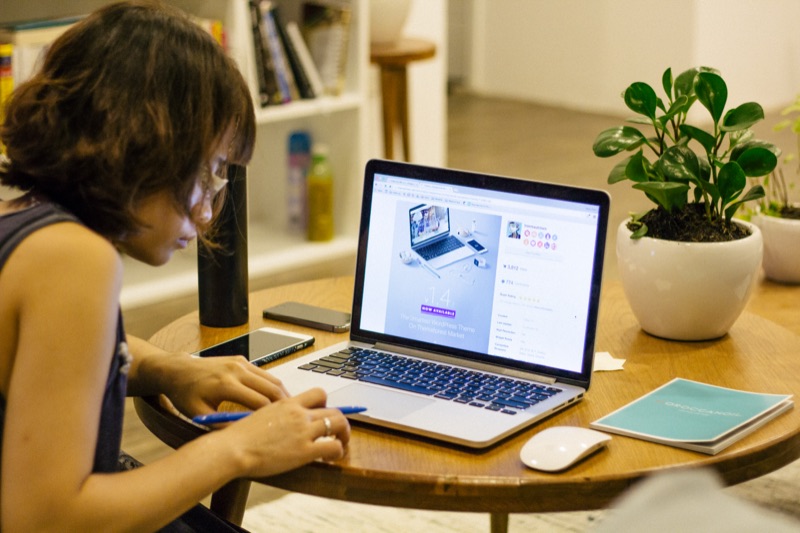 A designer working remotely on a laptop while traveling