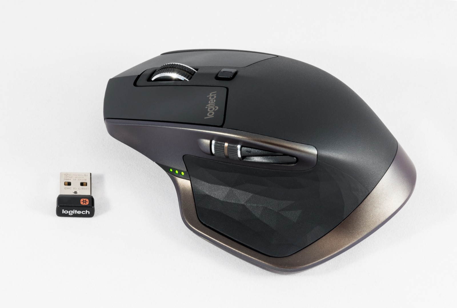 The graphite Logitech MX Master 2S wireless mouse with its Unifying USB receiver