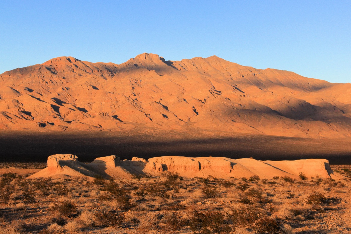 Golden evening light on desert badlands and mountains near Tule Springs, northwest of Las Vegas